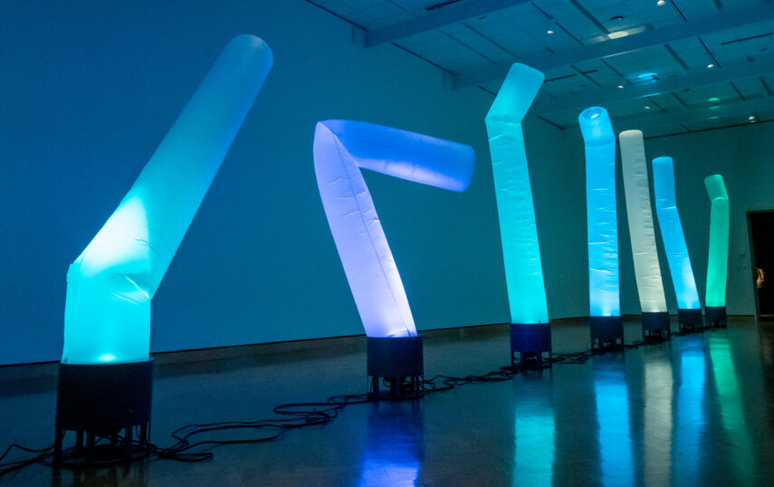 Illuminated nylon wind socks billow vertically in the museum gallery.