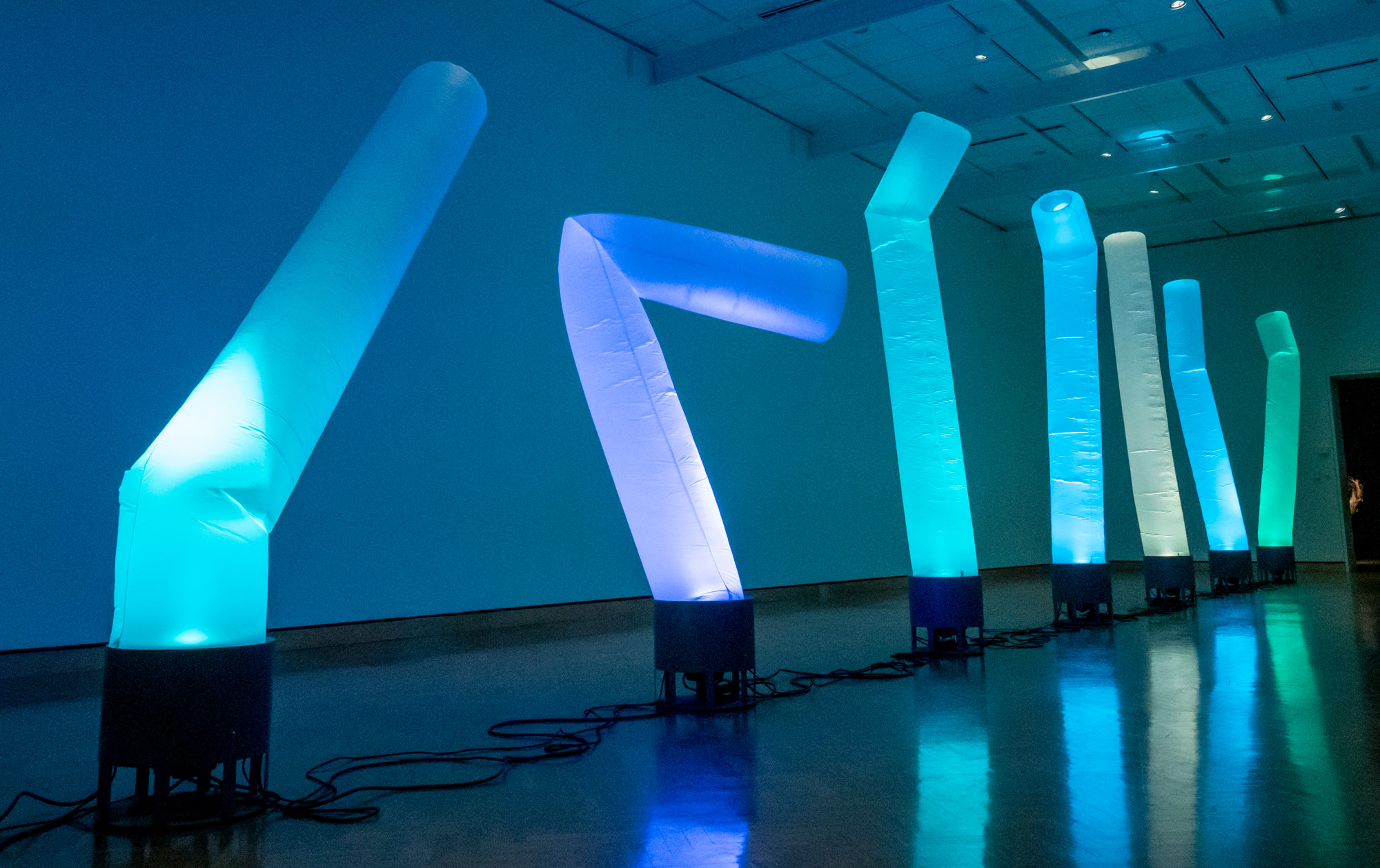 Illuminated nylon wind socks billow vertically in the museum gallery.